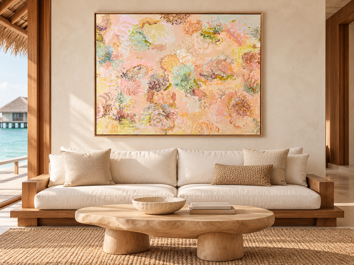 Under the Waves canvas art print by Prudence De Marchi, shown in a timber frame above a linen sofa in a coastal living room.