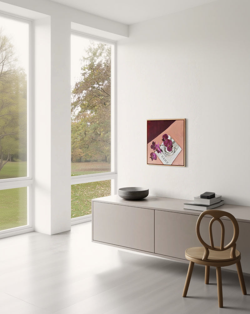 Modern interior with a large window, a piece of furniture with a bowl on it, and a framed artwork on the wall.