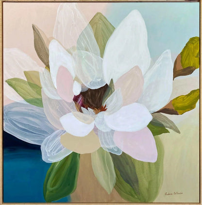 An acrylic painting of a magnolia flower with layered white, pale pink, and green petals, set against a split background of beige and blue, framed in a thin brown border.