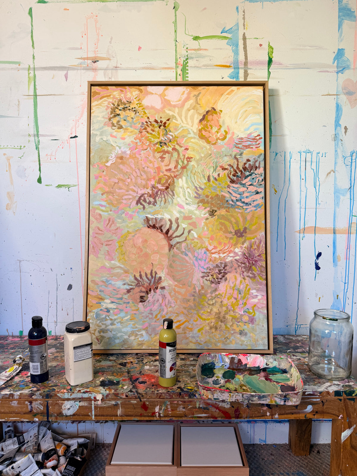 Original Coral Wandering painting by Prudence De Marchi displayed on a paint-covered studio table.
