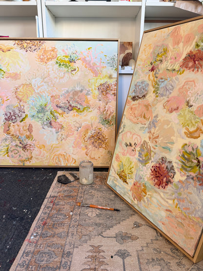 Under the Waves, a peach and pink landscape painting, displayed with another original artwork in Prudence De Marchi's studio.
